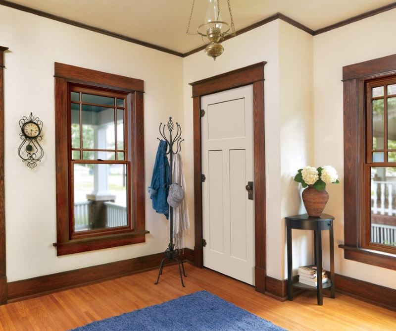 Brown platbands on a doorway with a white door