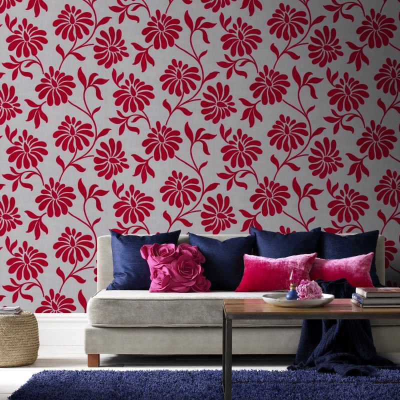 A contrasting combination of floral wallpaper with textiles in the living room