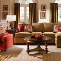 The combination of a brown sofa with a red armchair