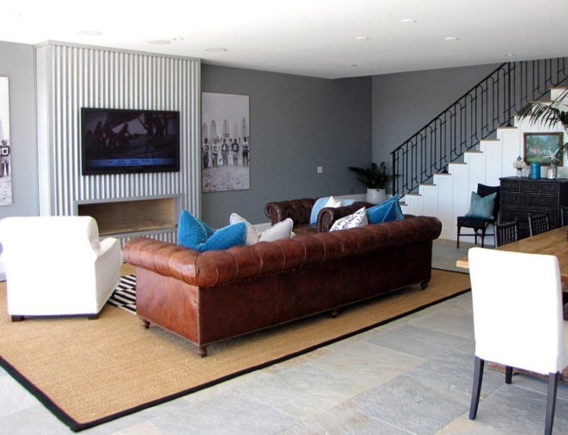 Brown sofa with leather upholstery on the carpet in the living room