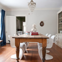 Retro solid wood table and modern plastic chairs