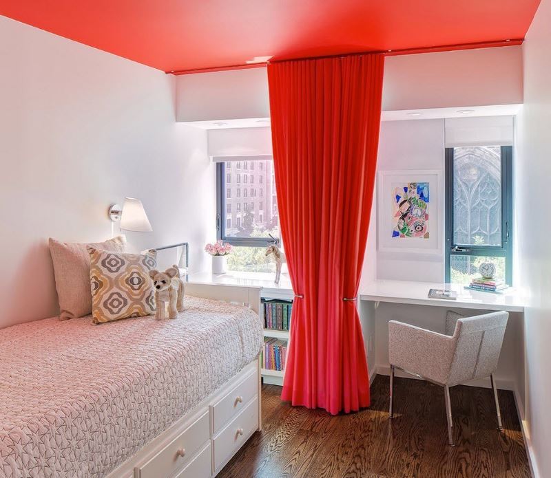Red curtain in the interior of a white room for a teenage girl