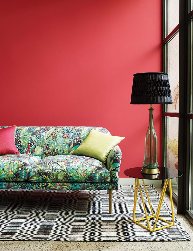 Variegated sofa against a red wall