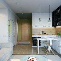 The combination of black and pastel colors in the design of the kitchen