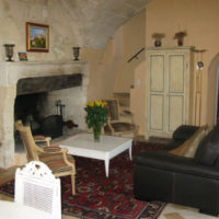 Sofa in front of a fireplace in a rural kitchen