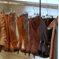 Women's boots on clothespins in the closet
