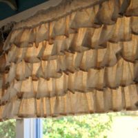 Burlap curtains in the design of the kitchen window