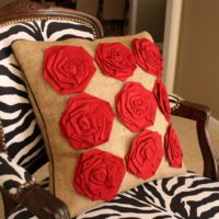 Red roses on a burlap pillow