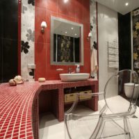 Finishing the countertops in the bathroom with red mosaic