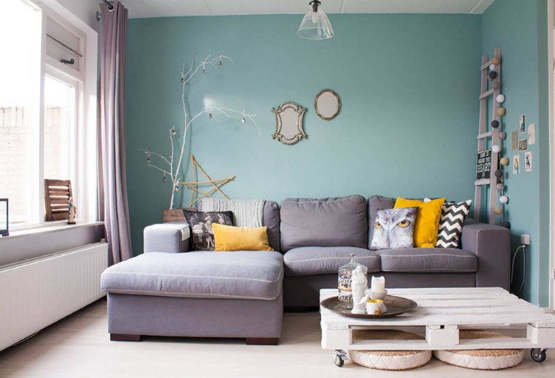 The design of the living room of a city apartment in mint color