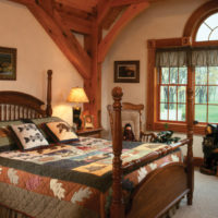 Colorful textile on a bed in a rustic bedroom