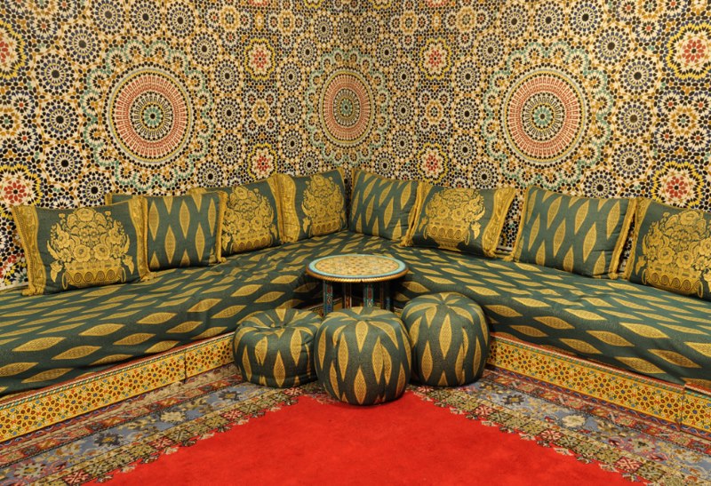 Corner sofa with bright upholstery in the interior of the Moroccan style