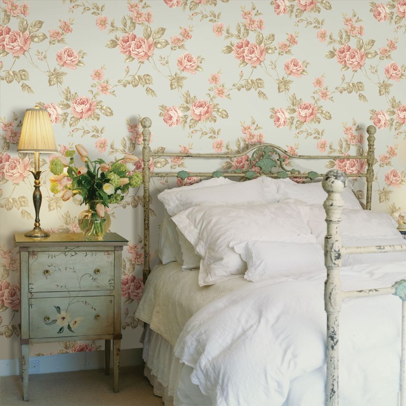 Decoration of the bedroom wall with floral wallpaper in a rustic style