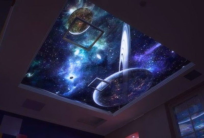 Stretch ceiling with the image of fantastic planets