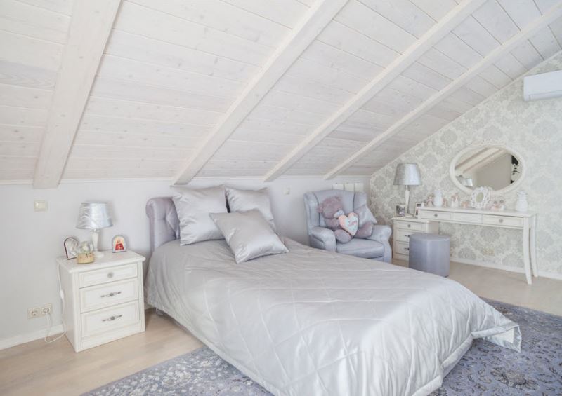 Bed for a teenage girl in the attic of a private house