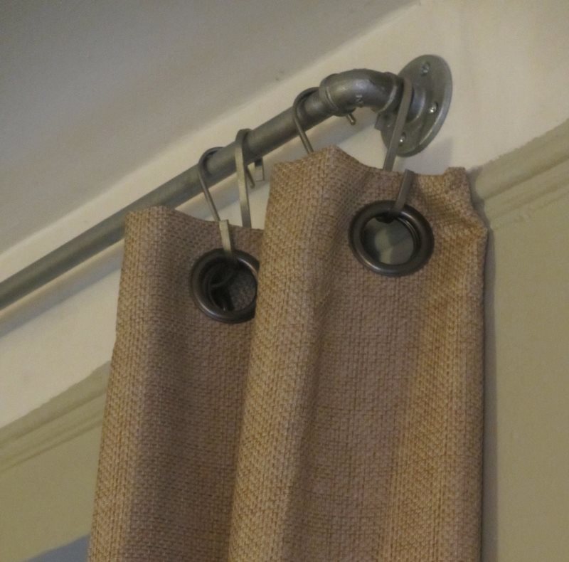Hanging curtains from burlap to the ledge with hooks