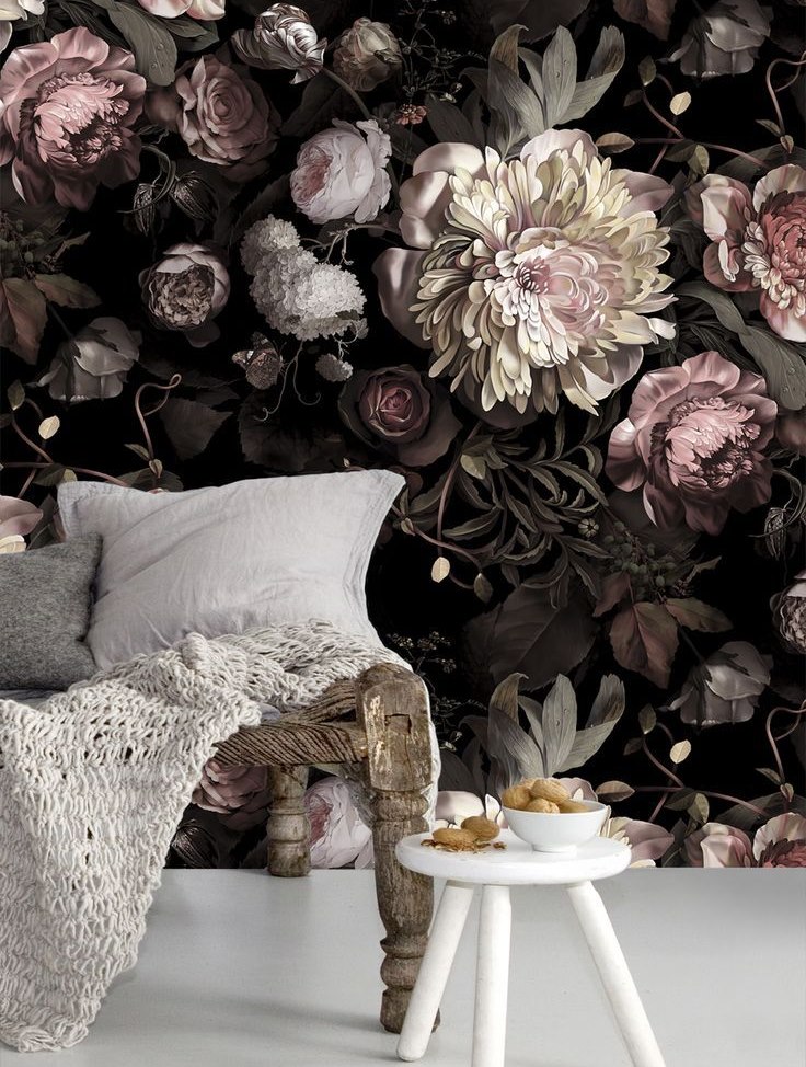 Bright floral wallpaper on the wall behind a wooden couch