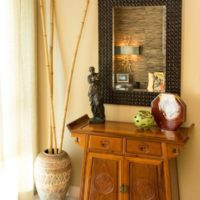 Wooden chest of drawers under the wall mirror