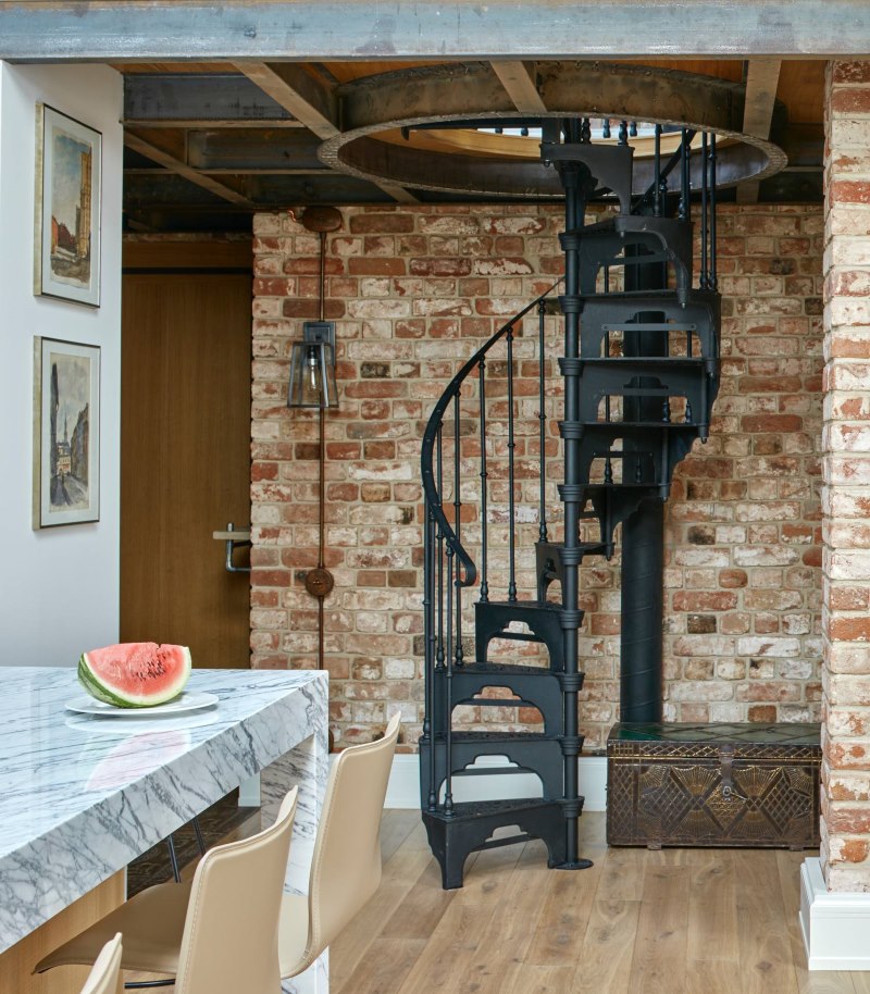 Black metal spiral staircase to the second floor of the loft