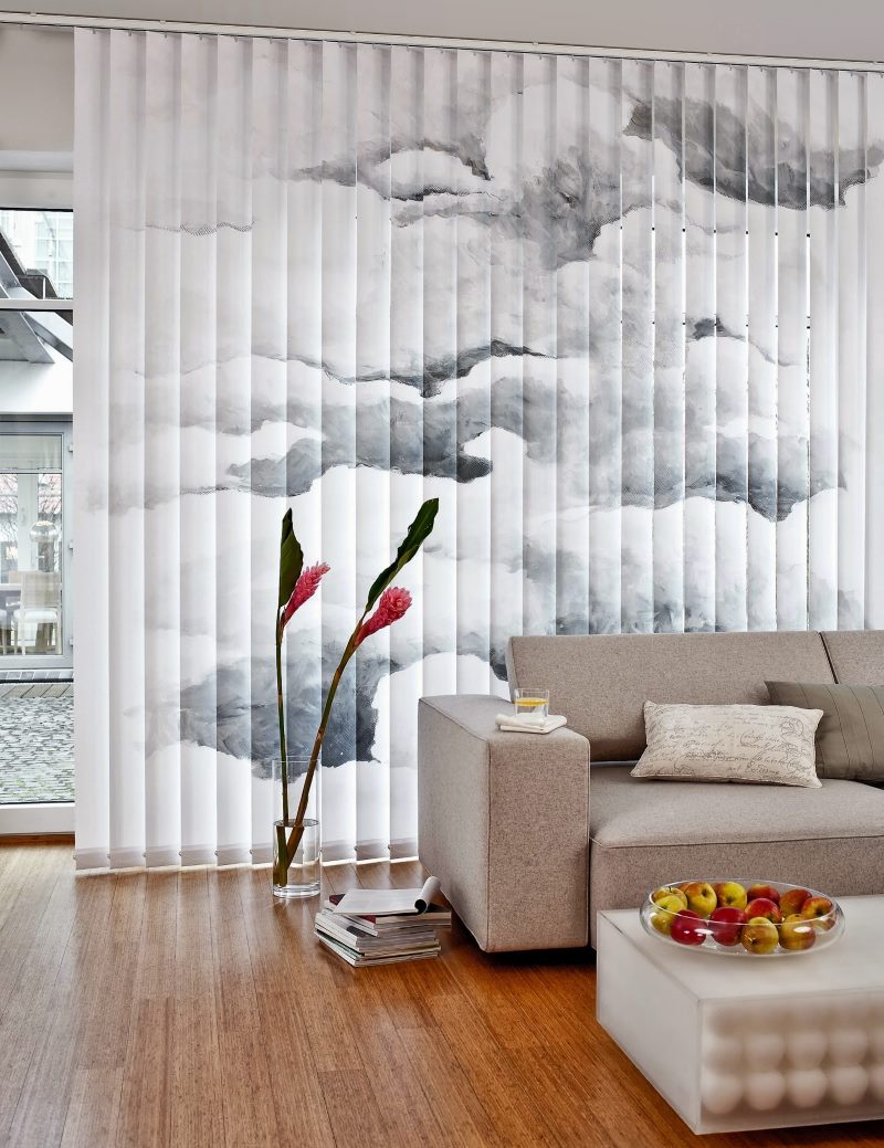 Gray sofa against the background of vertical blinds