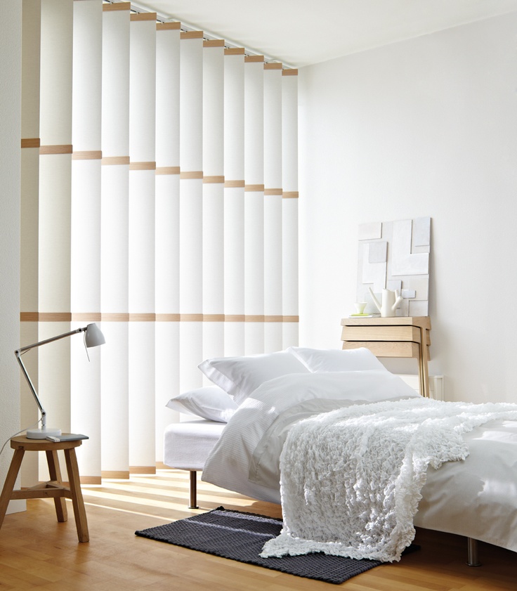Vertical fabric blinds in a white bedroom
