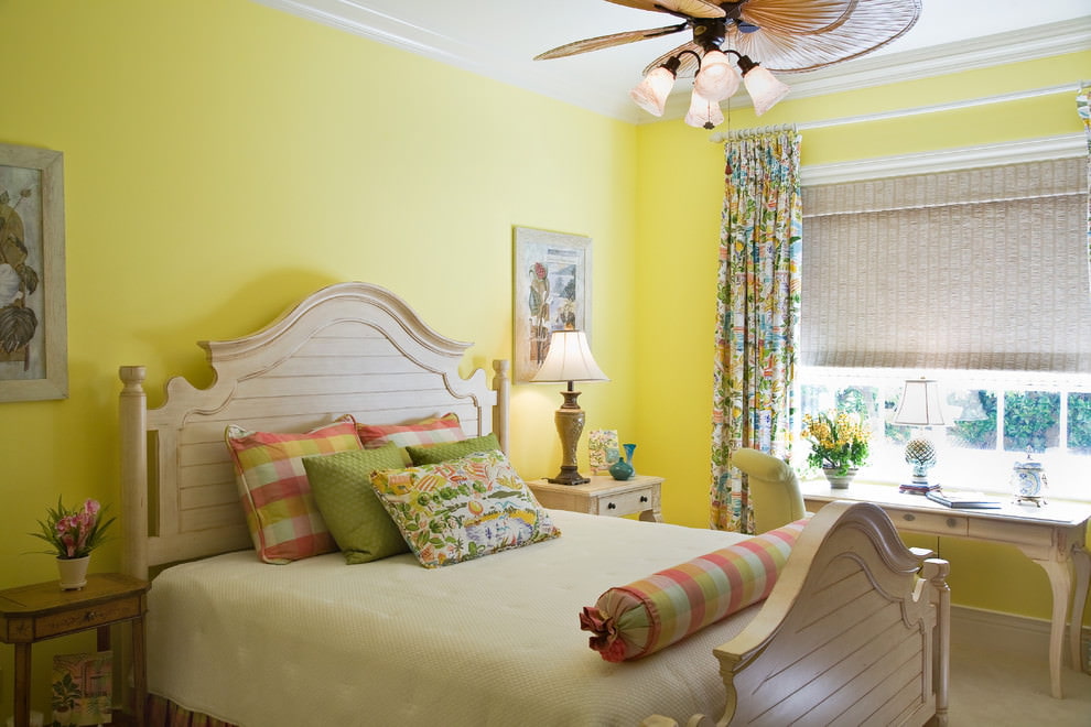 Painting the walls of the bedroom in a yellow tint
