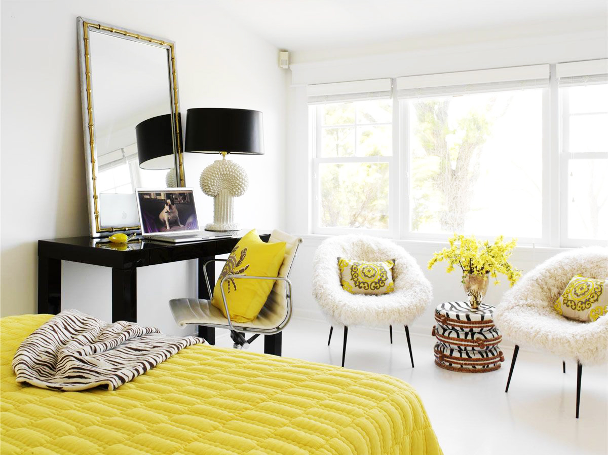 Yellow bedspread in a white bedroom