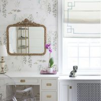 Mirror on the wall with floral wallpaper