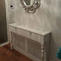 Decorative screen with curly legs to mask the heating radiator