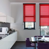 Red roller blinds in a white kitchen