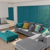 Turquoise blinds in the living room with a gray sofa