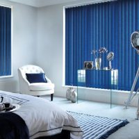 Blue blinds in the bedroom of a city apartment