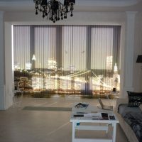 City lights through ajar blinds