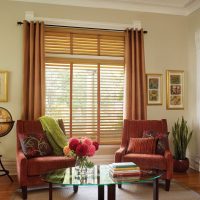 Curtains on the window with wooden shutters.