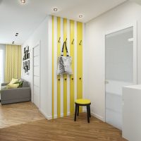 Yellow hanger with hooks in the hallway of a country house