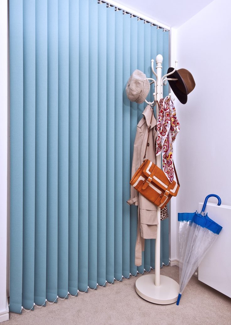 Clothes hanger near vertical fabric blinds