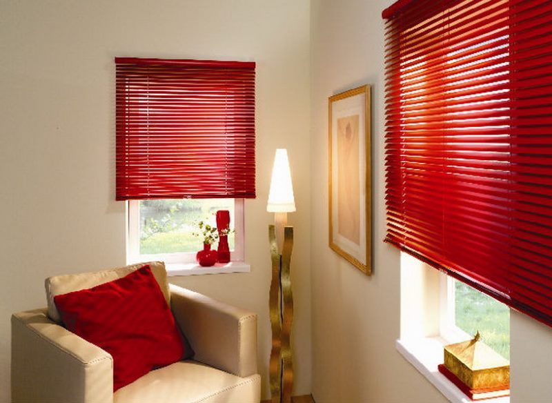Red pillow in a room with shutters