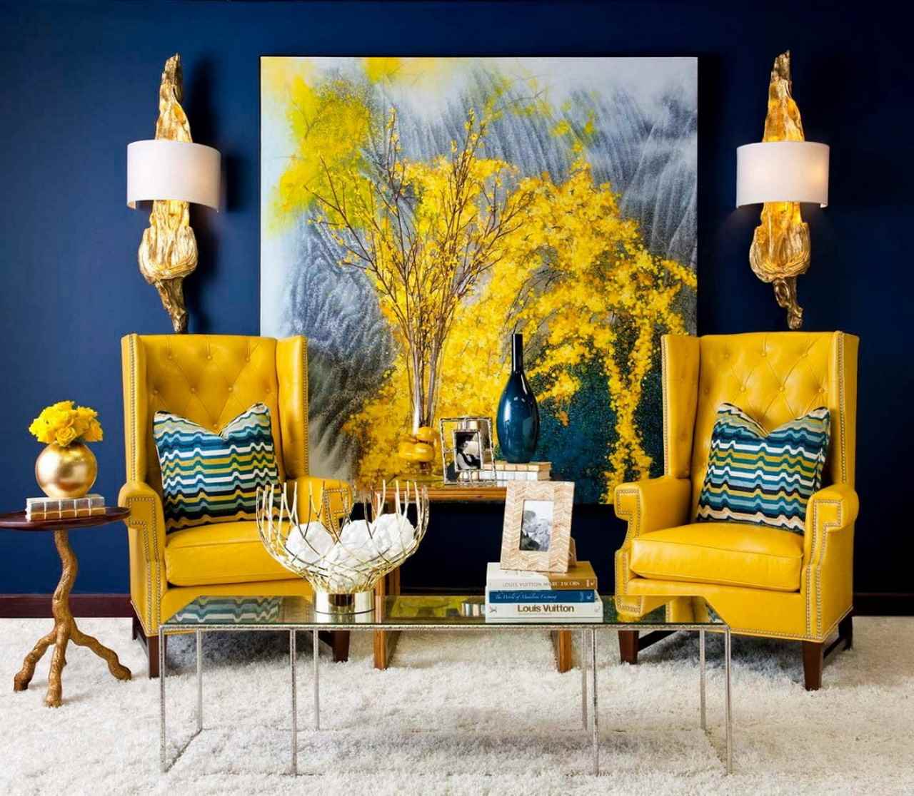 Two yellow armchairs in a living room with a blue wall