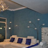 The decoration of the walls and ceiling of the living room with liquid wallpaper