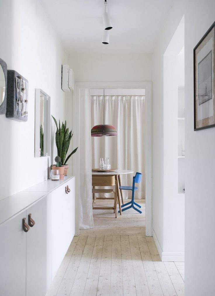 Plancher en bois clair dans le couloir avec des murs blancs