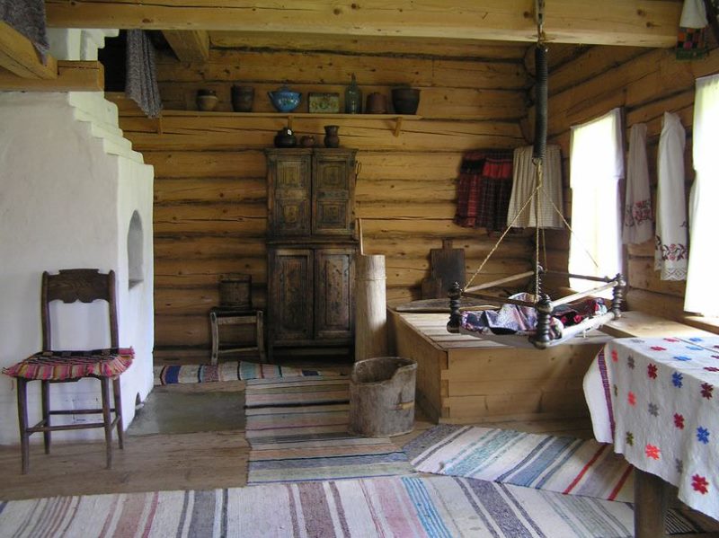 Bleached stove in a log cabin of the old Russian style