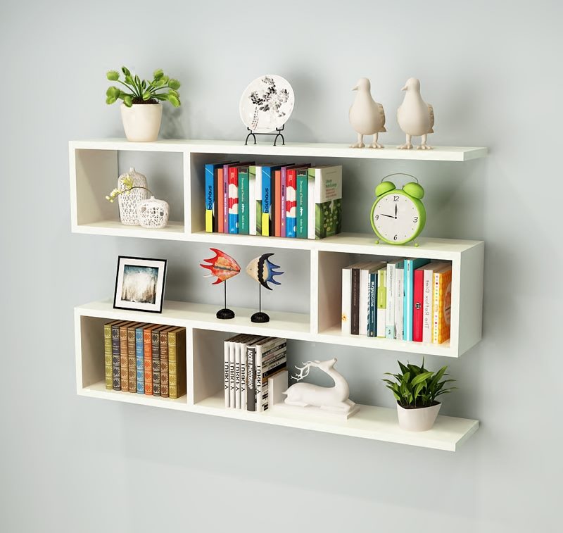 White open shelves with books and souvenirs