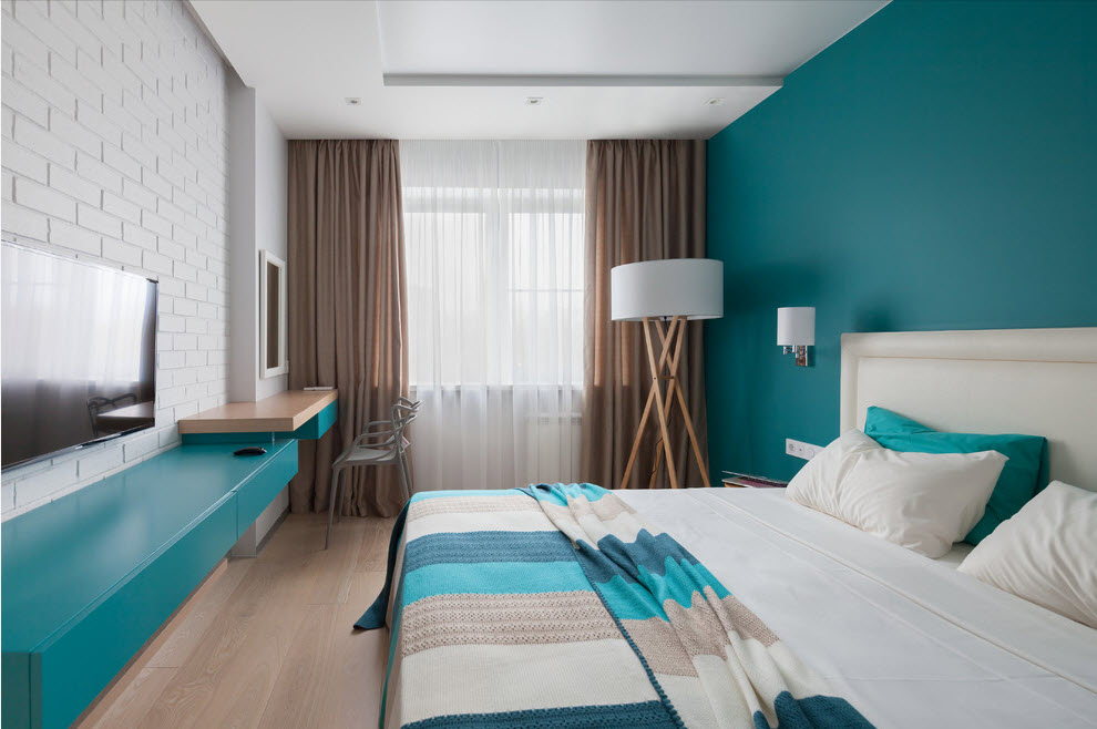 Turquoise wall in an elongated bedroom
