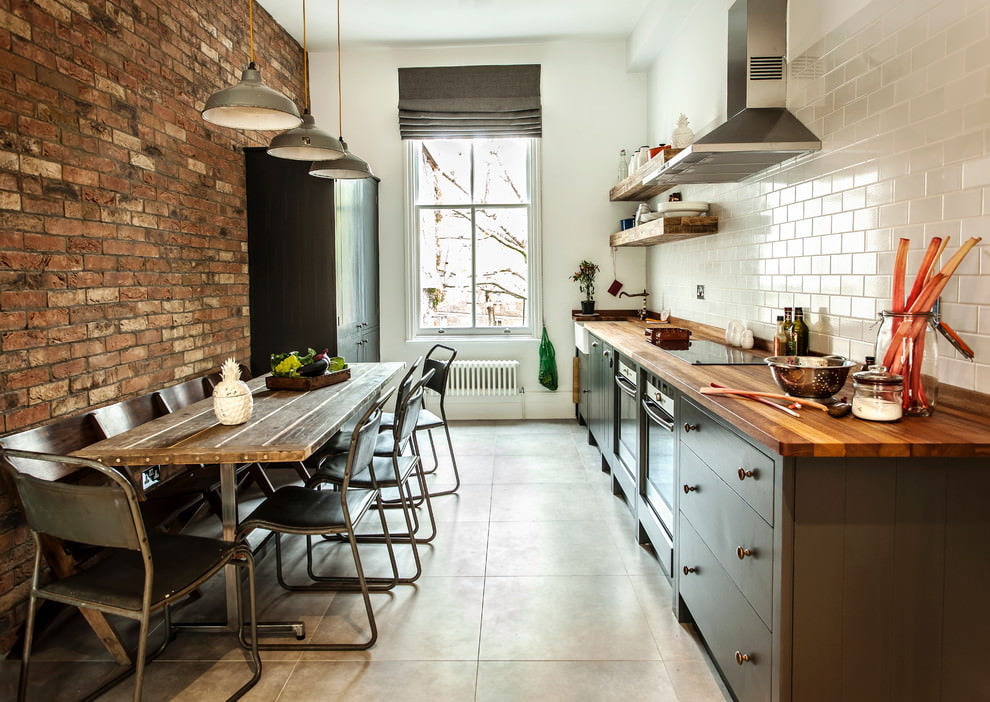 Design of an elongated kitchen with brick walls