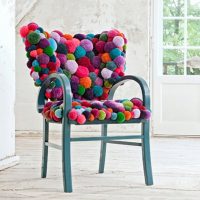 Decor of an old chair with soft pompons