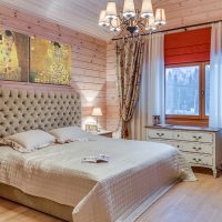 Bright bedroom in a house made of timber