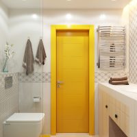 Yellow door in the interior of the combined bathroom