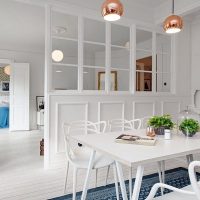 White dining table in a three-room apartment
