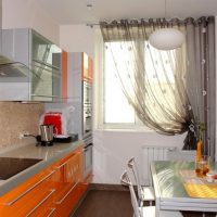 Linear kitchen with orange facades