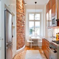 Wooden floor in a bright narrow kitchen
